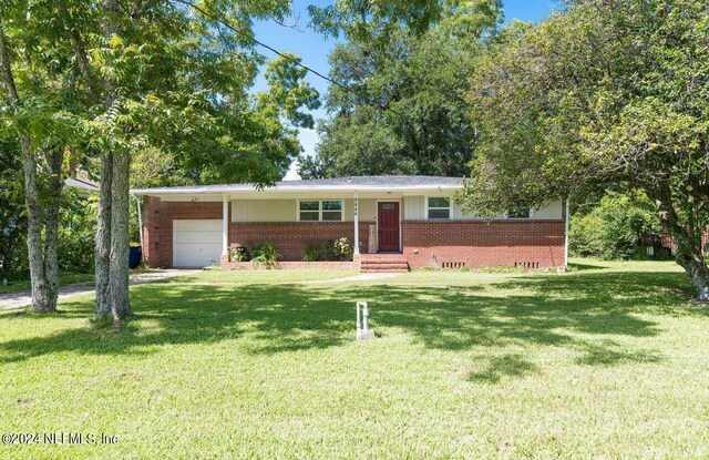 ranch-style home with a garage and a front yard