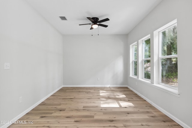 spare room with ceiling fan and light wood-type flooring