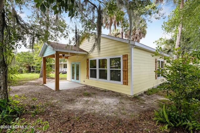 rear view of house with french doors, ceiling fan, and a patio area