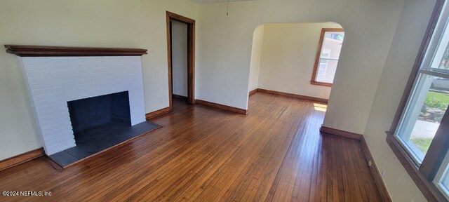 unfurnished living room featuring a fireplace and wood-type flooring