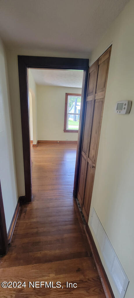 hallway with dark wood-type flooring