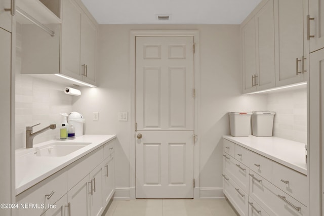 interior space with sink and light tile patterned flooring