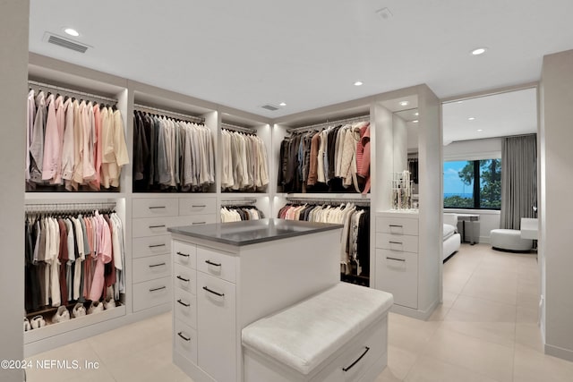 walk in closet with light tile patterned flooring