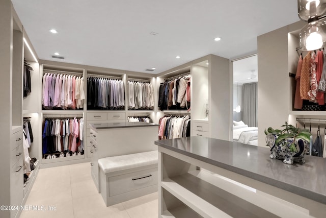 walk in closet featuring light tile patterned flooring