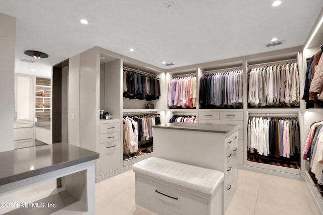 spacious closet with light tile patterned flooring