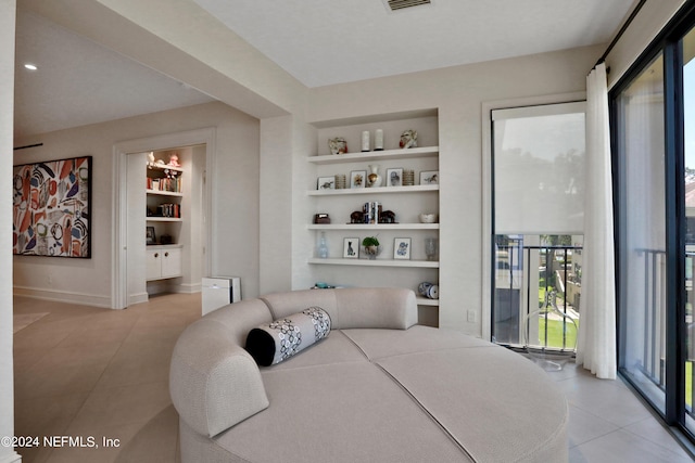 bedroom featuring access to exterior and light tile patterned floors