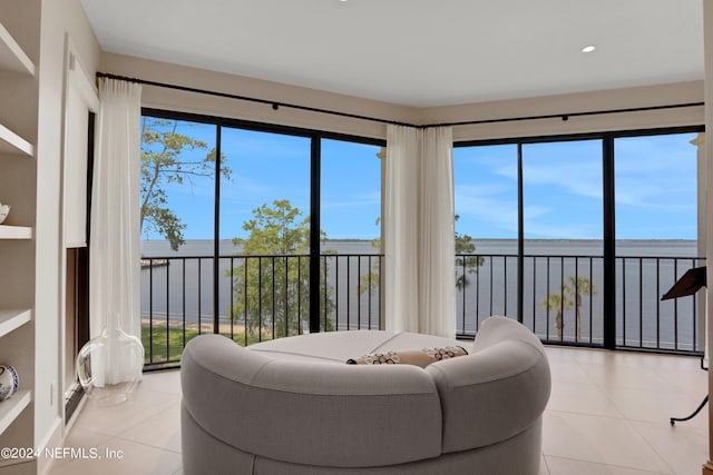 tiled living room featuring a water view