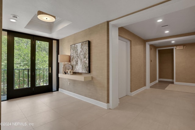 entryway with a tray ceiling