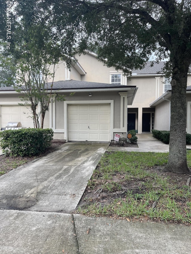 4727 Playpen Dr, Jacksonville, FL 32210 - view of front facade featuring a garage