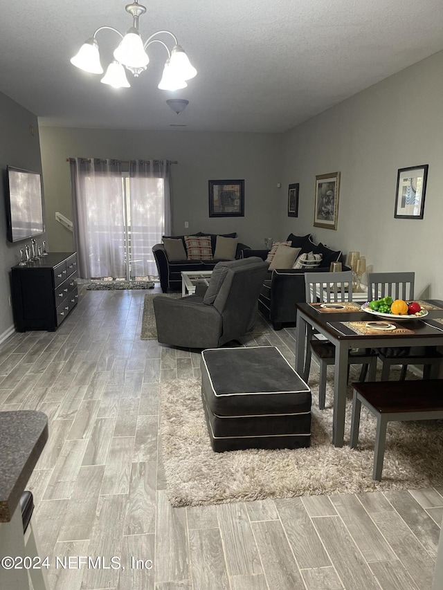 living room featuring lofted ceiling and a chandelier