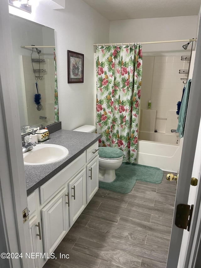 full bathroom featuring shower / bathtub combination with curtain, vanity, and toilet