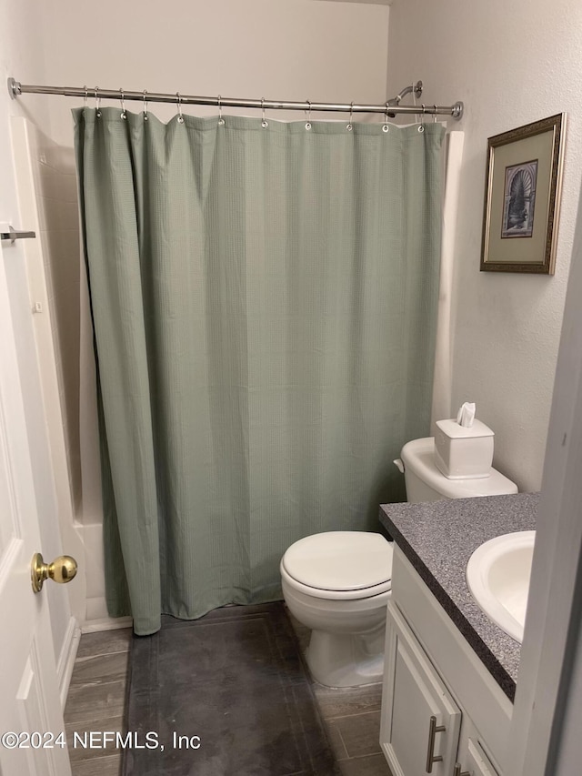 bathroom with vanity, toilet, and curtained shower