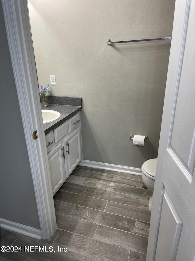 bathroom featuring vanity and toilet