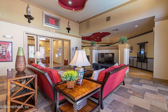 interior space featuring french doors, stone finish floor, and visible vents