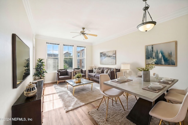 living area with ceiling fan, baseboards, wood finished floors, and crown molding