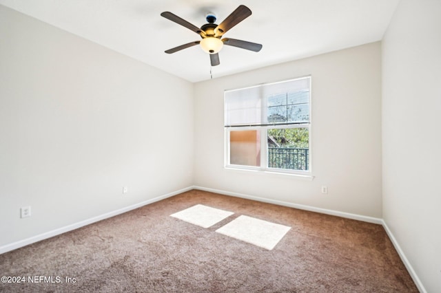 spare room featuring a ceiling fan, baseboards, and carpet flooring