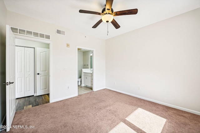 unfurnished bedroom with carpet, visible vents, and baseboards