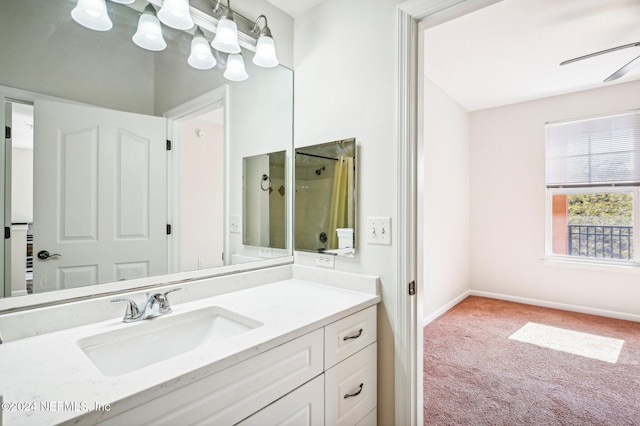 bathroom with baseboards, a shower, vanity, and a ceiling fan