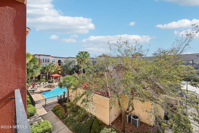 pool featuring central air condition unit and a patio area