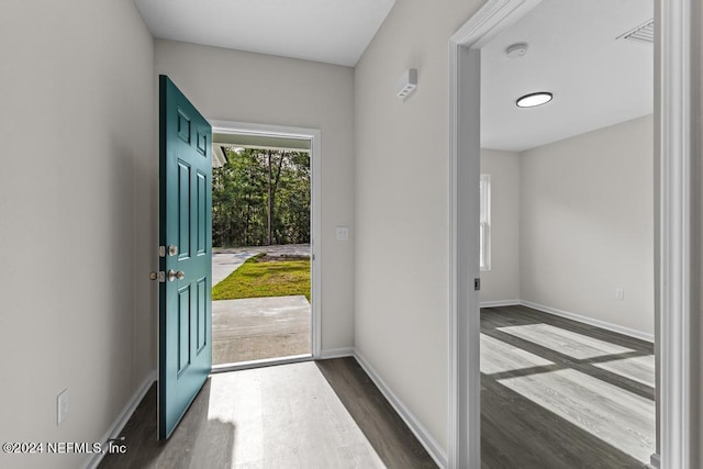 foyer with baseboards and dark wood finished floors