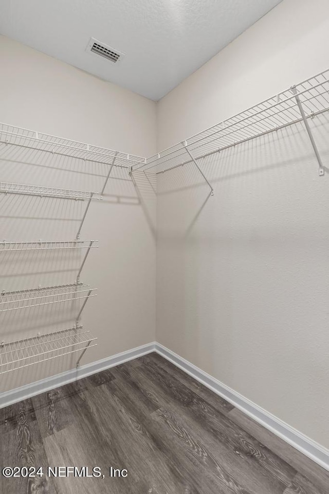 walk in closet featuring hardwood / wood-style floors