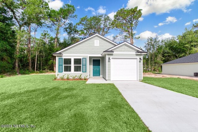 view of front facade with driveway, a front lawn, and an attached garage