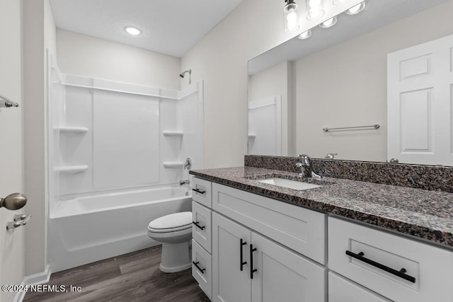 full bathroom with shower / bathtub combination, vanity, hardwood / wood-style flooring, and toilet