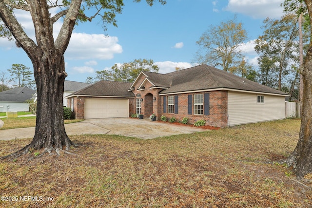 single story home with a front lawn, brick siding, driveway, and an attached garage