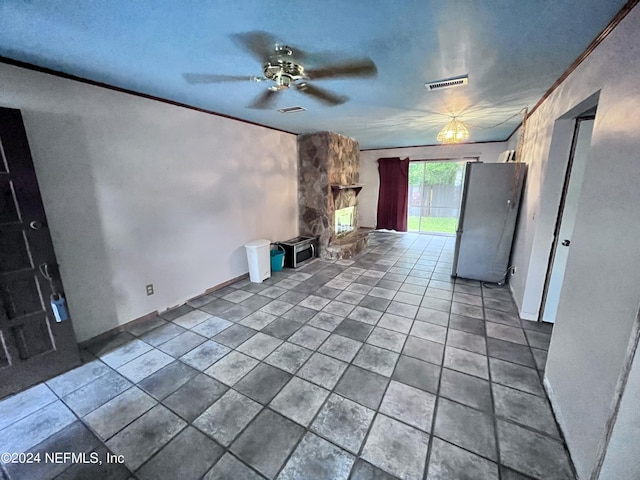 unfurnished living room with ceiling fan, ornamental molding, and tile patterned floors