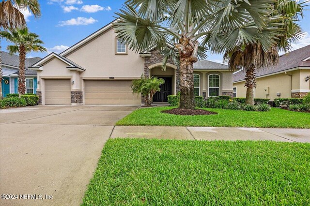 view of front of house featuring a garage and a front yard