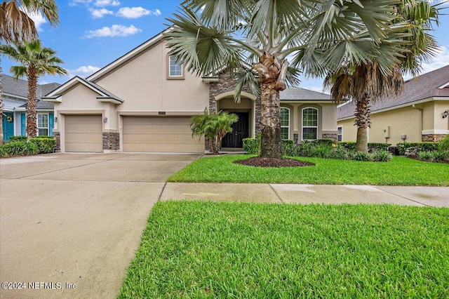 view of front of home with a garage and a front lawn