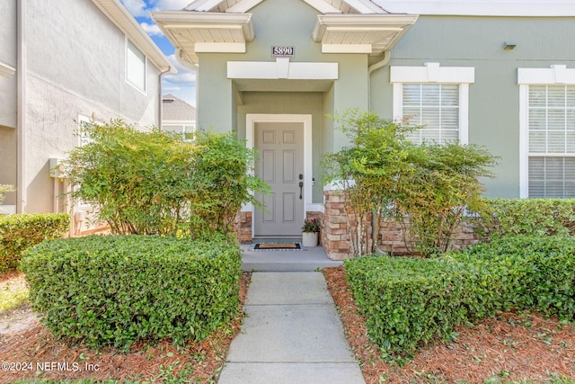 property entrance with stucco siding