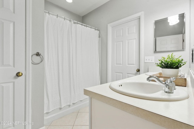 full bath with shower / bath combo, vanity, and tile patterned flooring