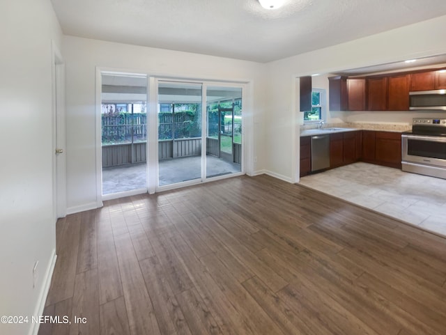 kitchen featuring sink, stainless steel appliances, and light hardwood / wood-style floors