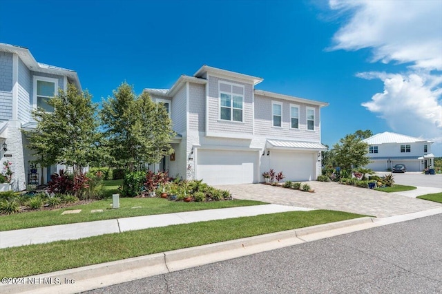 view of front facade featuring a garage and a front lawn