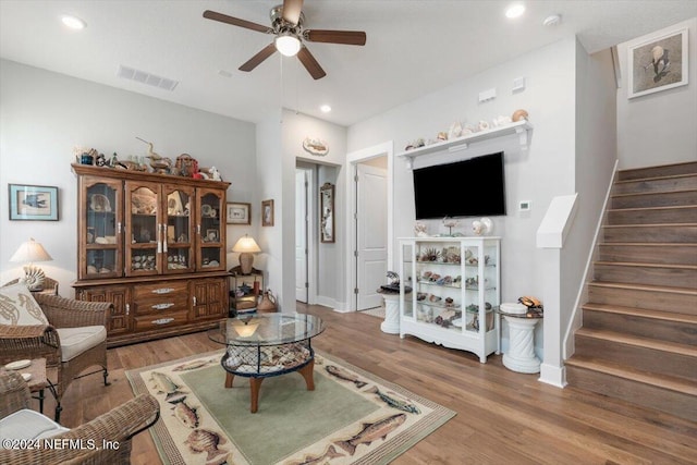 living room with hardwood / wood-style flooring and ceiling fan