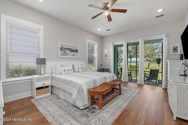 bedroom with access to exterior, hardwood / wood-style flooring, and ceiling fan