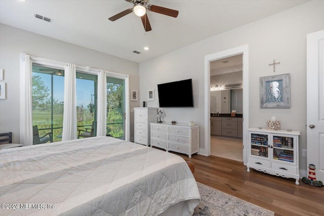 bedroom with ceiling fan, ensuite bathroom, access to exterior, and dark hardwood / wood-style flooring