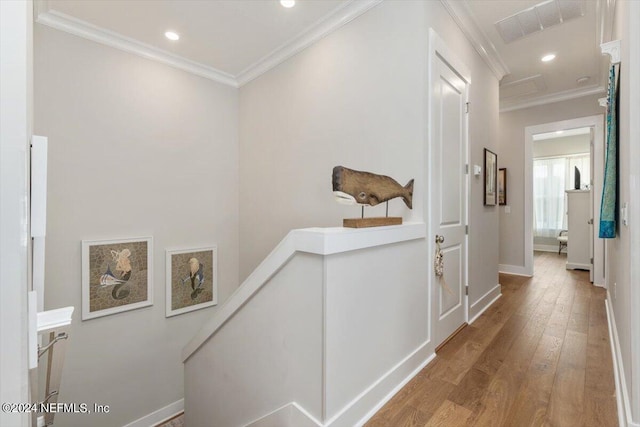 hall featuring wood-type flooring and ornamental molding