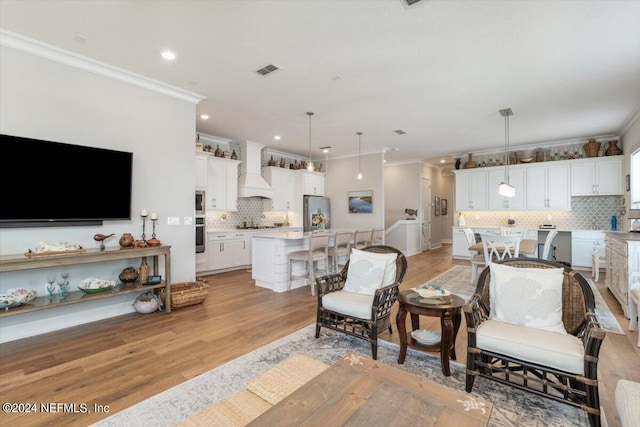 living room featuring crown molding and light wood-type flooring