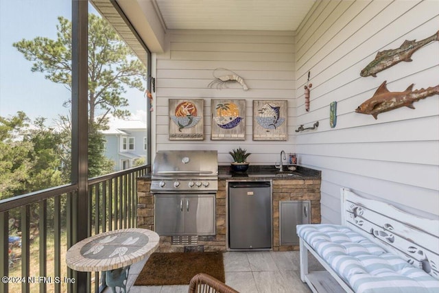 view of patio / terrace featuring sink, grilling area, a balcony, and exterior kitchen