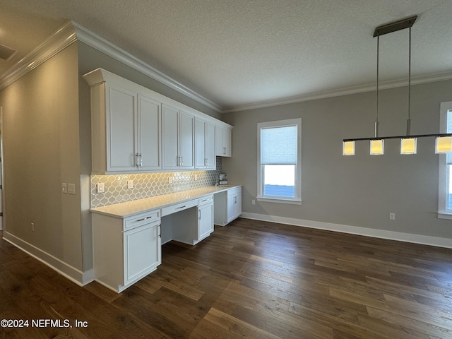 kitchen featuring white cabinetry, dark hardwood / wood-style floors, built in desk, decorative backsplash, and decorative light fixtures