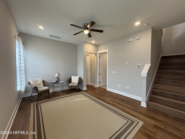 unfurnished room featuring dark wood-type flooring, ceiling fan, and a textured ceiling