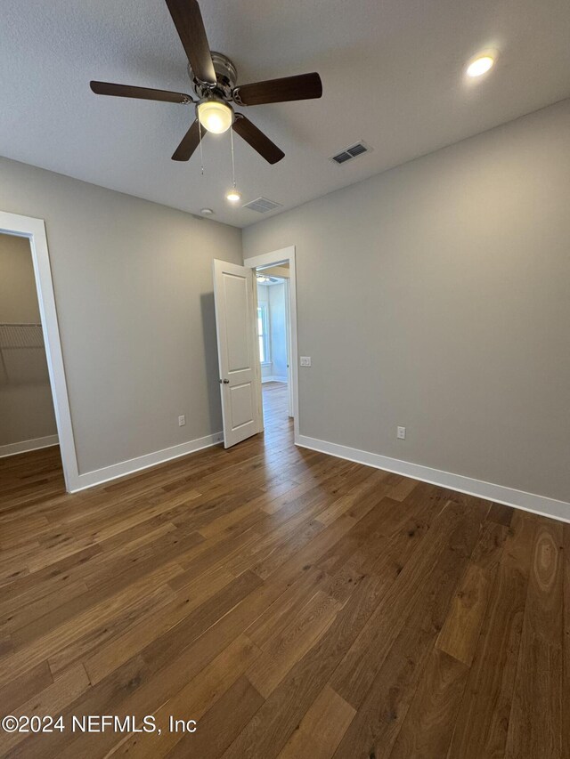 unfurnished room featuring ceiling fan and dark hardwood / wood-style floors