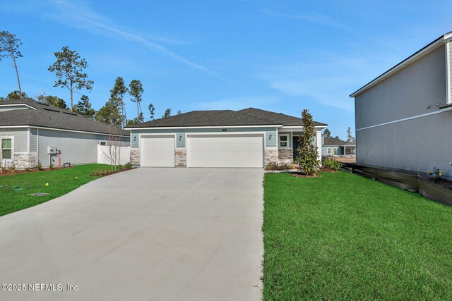 view of front of home with a garage and a front yard