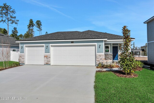 view of front of home with a garage and a front yard