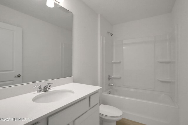 full bathroom featuring vanity, bathing tub / shower combination, and toilet