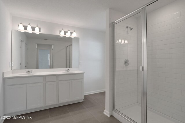 bathroom with vanity, tile patterned flooring, and a shower with door