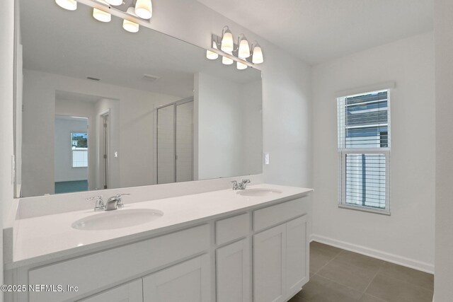 bathroom with vanity, tile patterned flooring, and a shower with door