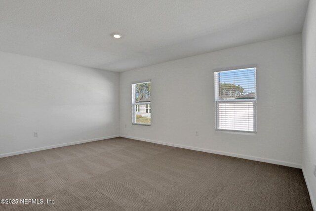 unfurnished room featuring light colored carpet